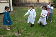 Three girls playing quoits.