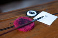 A small circular piece of pink felt used to clean pen nibs