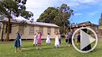 Teacher and students performing a routine with dumbbells in the playground