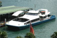 A blue and white river cat berthed beside a wharf.