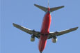 A red and silver jet with two engines.