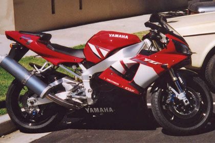 A shiny red and silver motorbike.