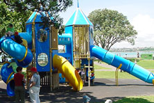 Blue and yellow outdoor play equipment with slides