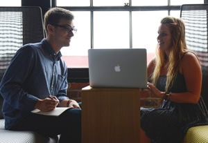 Two teachers planning and collaborating with a laptop