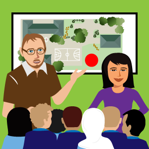 Mrs Chan and Mr Graham talking to the class with map of the school in the background