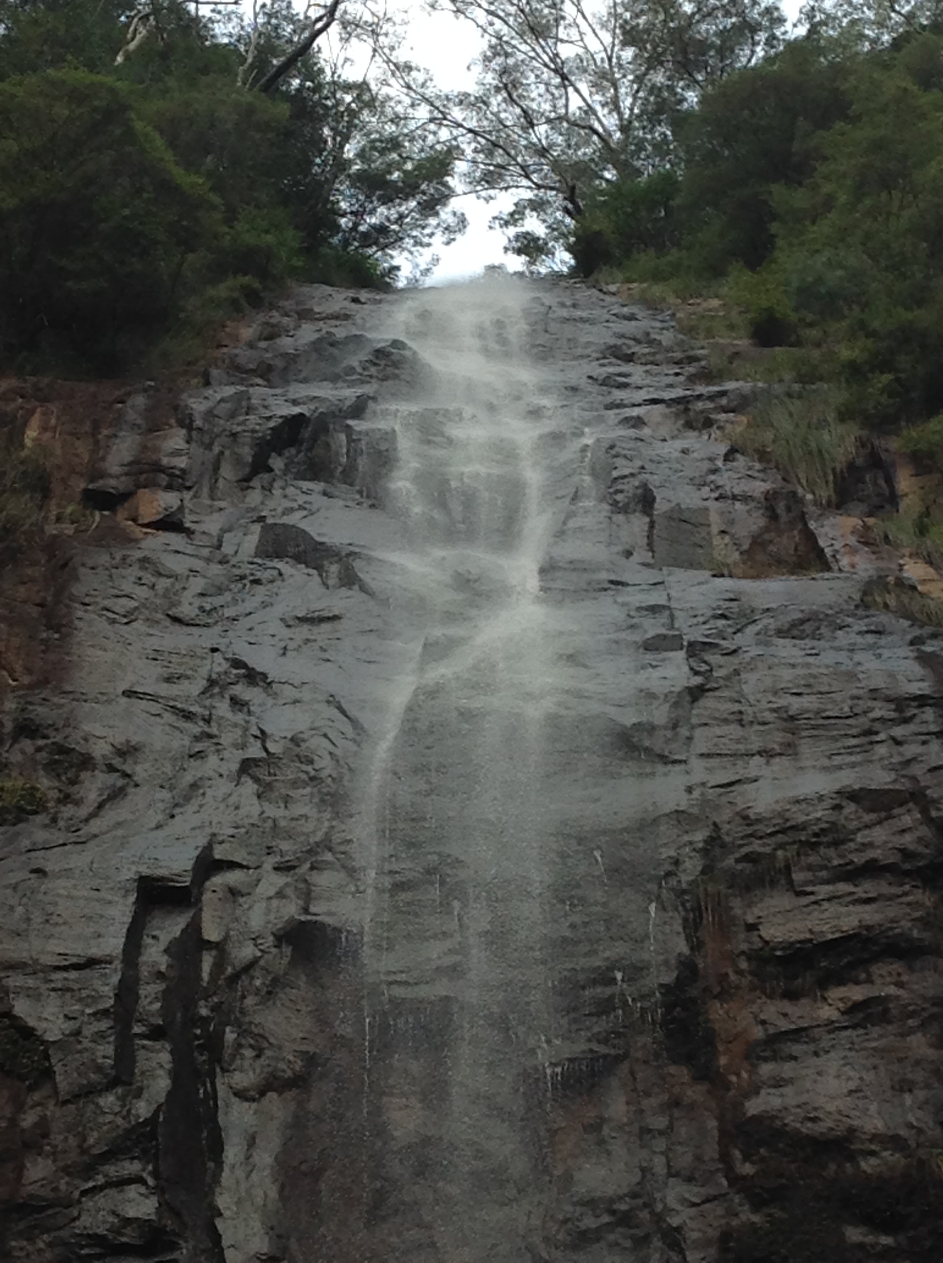 Close up image of a waterfall, on a basalt rock face.