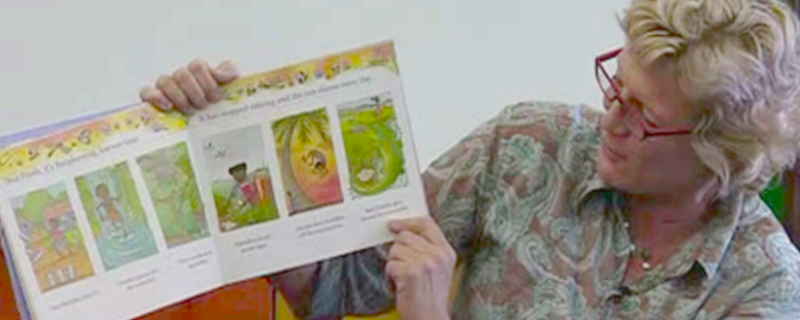 Alison Lester showing one of her picture books.