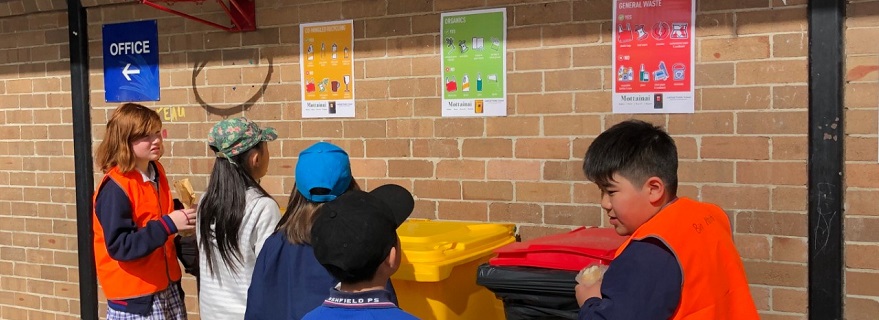 Monitors assist students to choose the correct bin for waste disposal.