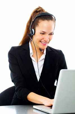 Office administration employee working at her desk. She is typing and answering calls.