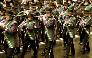 Young people marching in uniform playing instruments