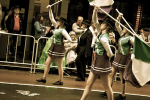 Students marching in uniform carrying flags Students marching in uniform carrying flags