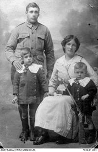 A family portrait circa 1915 of a uniformed man standing, a seated woman and two children. A family portrait circa 1915 of a uniformed man standing, a seated woman and two children.